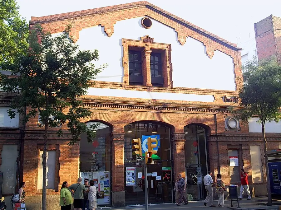 The brick facade of the Cotxeres de Sants civic centre on Carrer de Sants