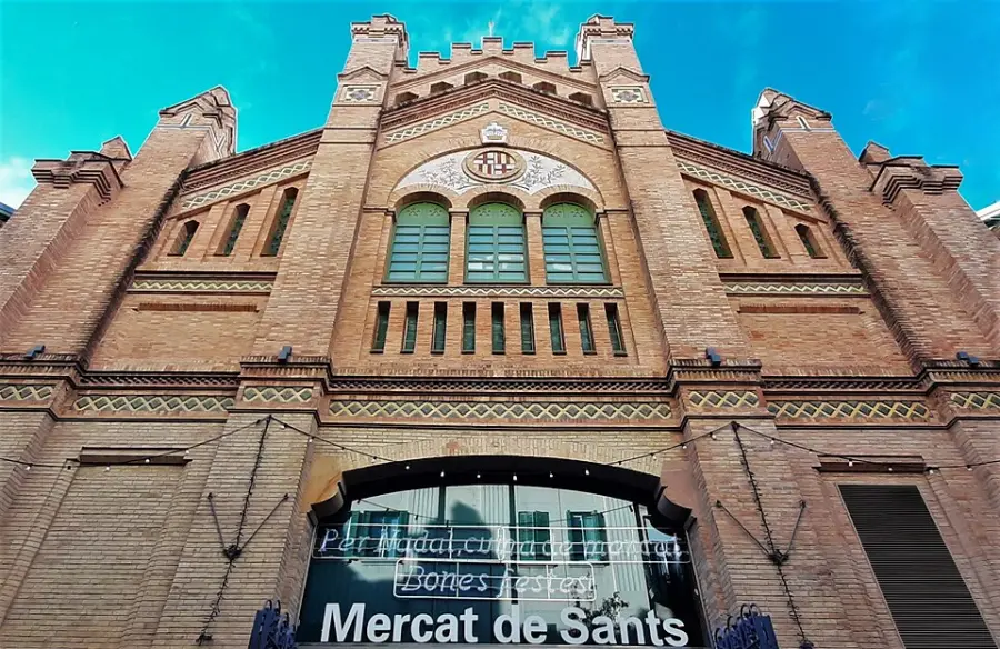 The exposed-brick facade of the Mercat de Sants with three arched windows